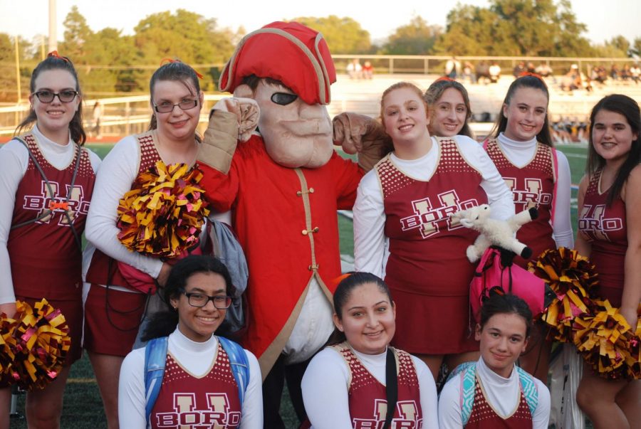 The Rockin' Raiders Cheer Team with the school mascot at the Franklin football game.