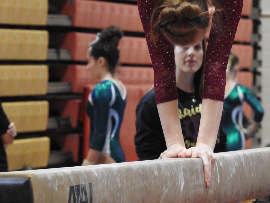 Junior Meghan Kurz, performing her balance beam routine. 