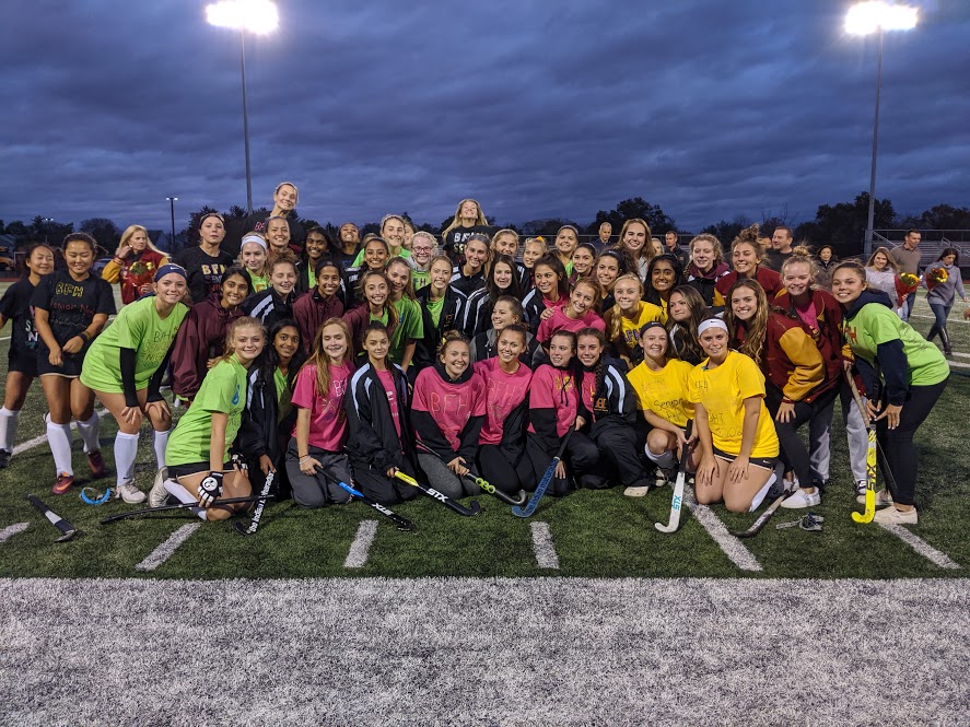 All three field hockey teams pose for a group shot at the opening ceremony for Senior Night.