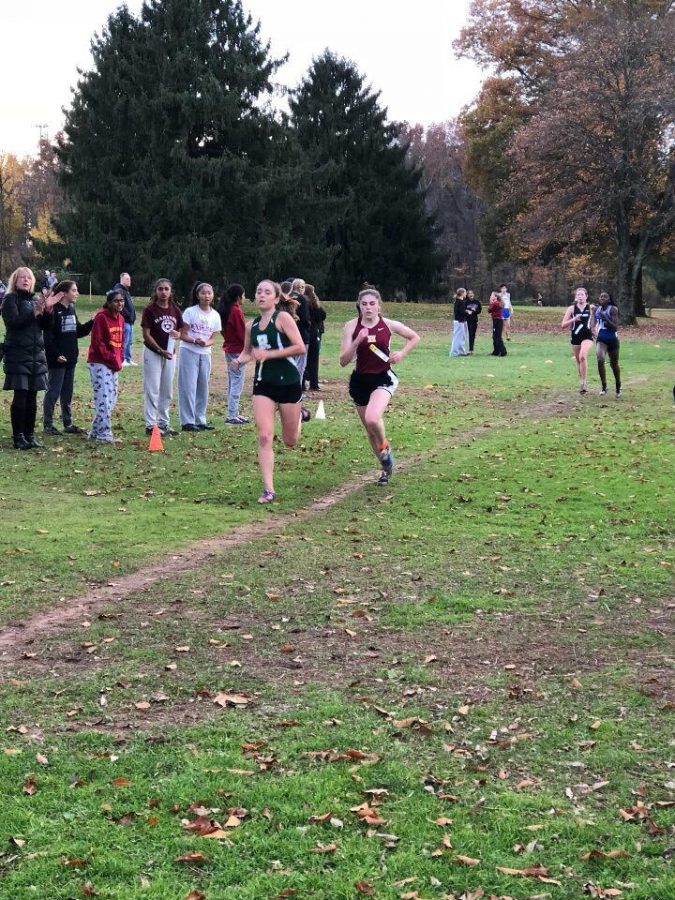 Senior Bridget Esposito tries to beat out her competitors as her teammates cheer her on. 
