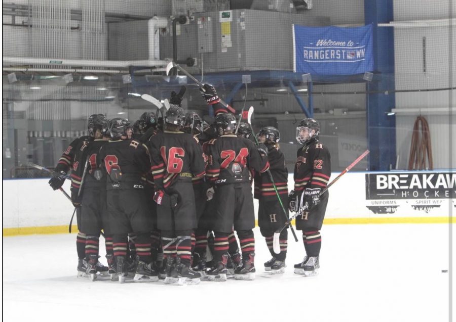 The 2019-20 Hillsborough Ice Hockey team huddles before a game.