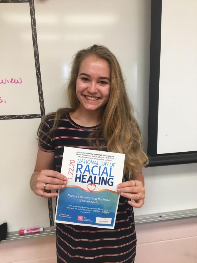 Senior Kaitlyn Dudorf holding the flyer for the Day of Racial Healing event. 