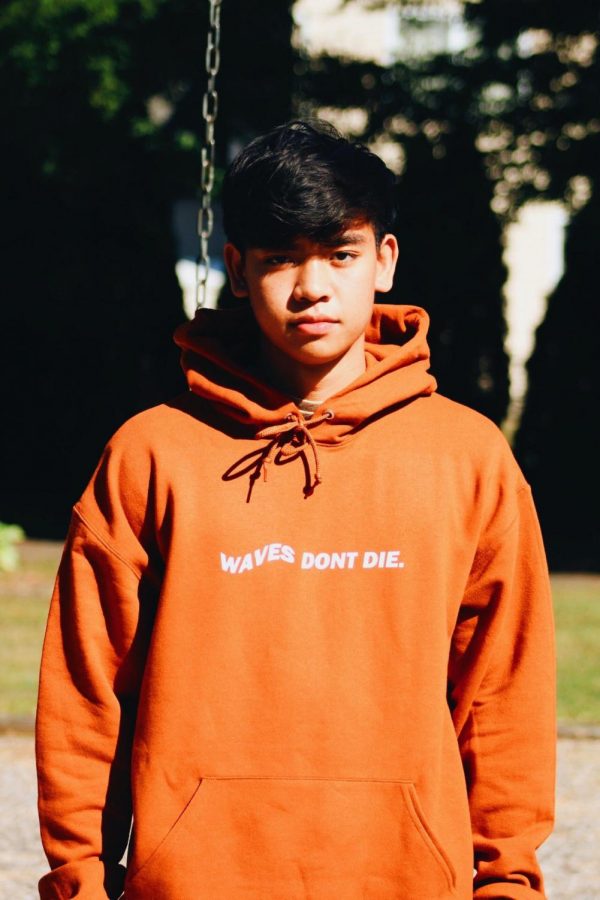 Junior Rocco George poses in a sweatshirt from his clothing line "Atlantic"