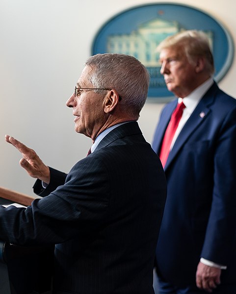 Dr. Anthony Fauci speaks beside President Trump at a White House press briefing. 