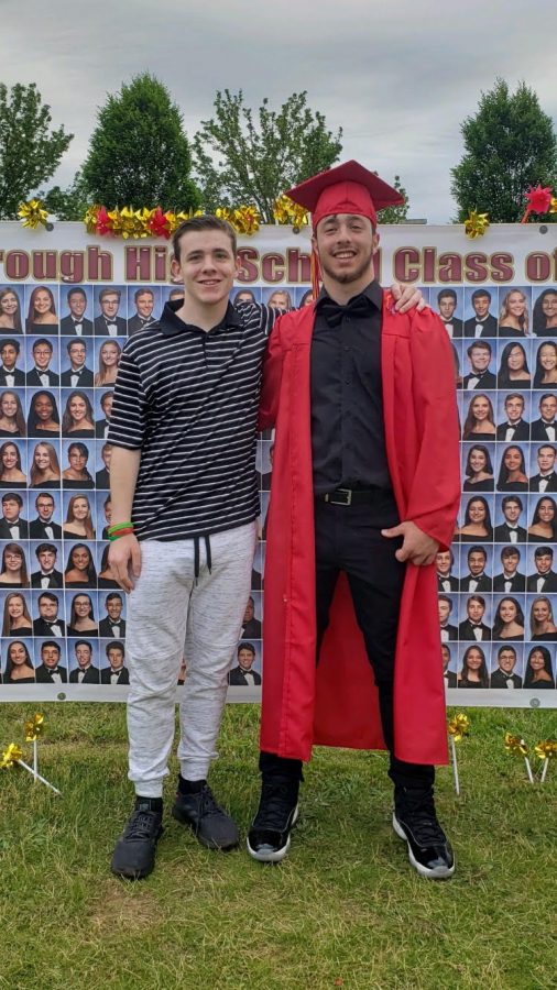 Senior Tony Scanelli celebrates his graduation outside HHS alongside family.