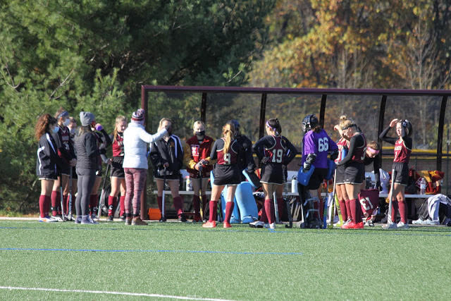 Varsity team gathering for a quick team meeting during halftime of a recent contest.