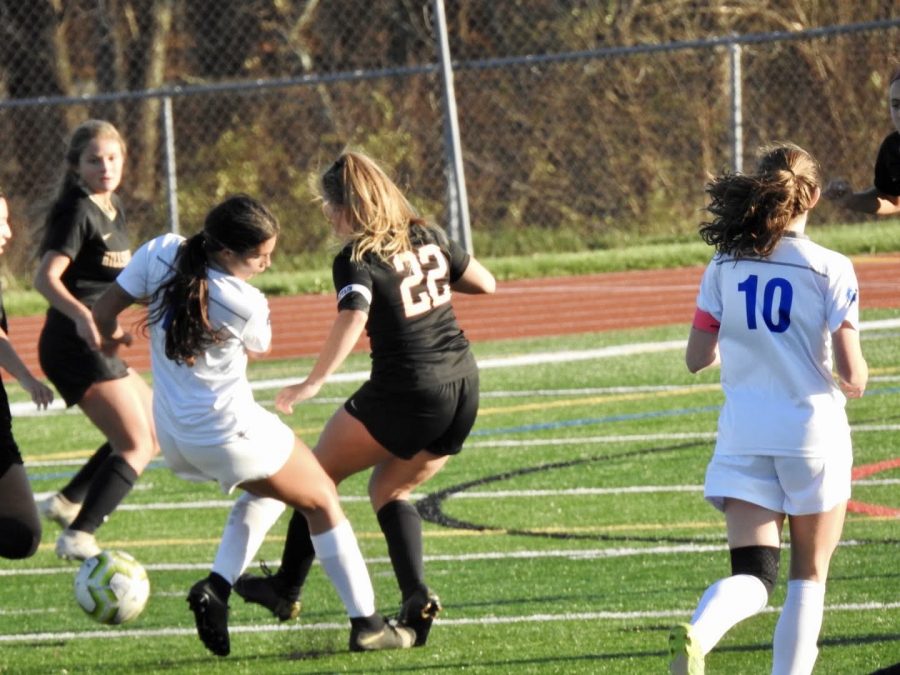 Kara Magliaro battles a Hightstown opponent for possession of the ball. 