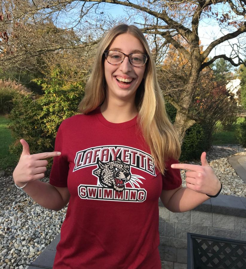 Senior Paige Griggs grins as she poses for a photo announcing her commitment to Lafayette College.