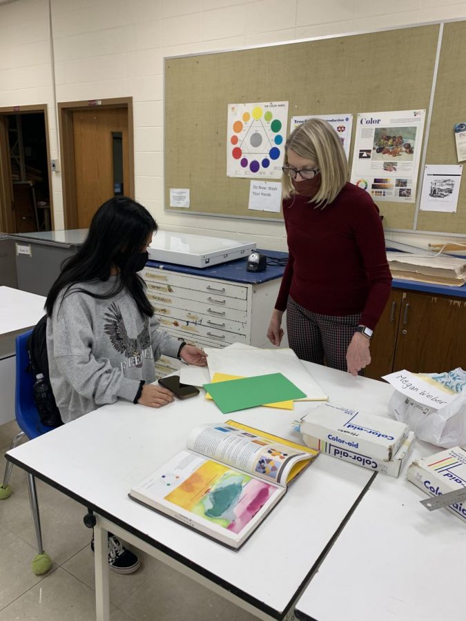 Art teacher Lynn Mound doing what she does best, guiding a student to success. 