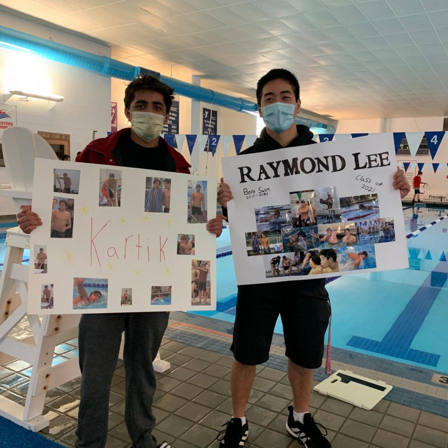 Seniors Kartik Kher (left) and Raymond Lee pose with the traditional senior night posters made for them by teammates. 