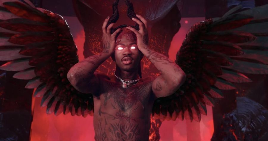 Lil Nas X poses as the devil with horns on the his head. 