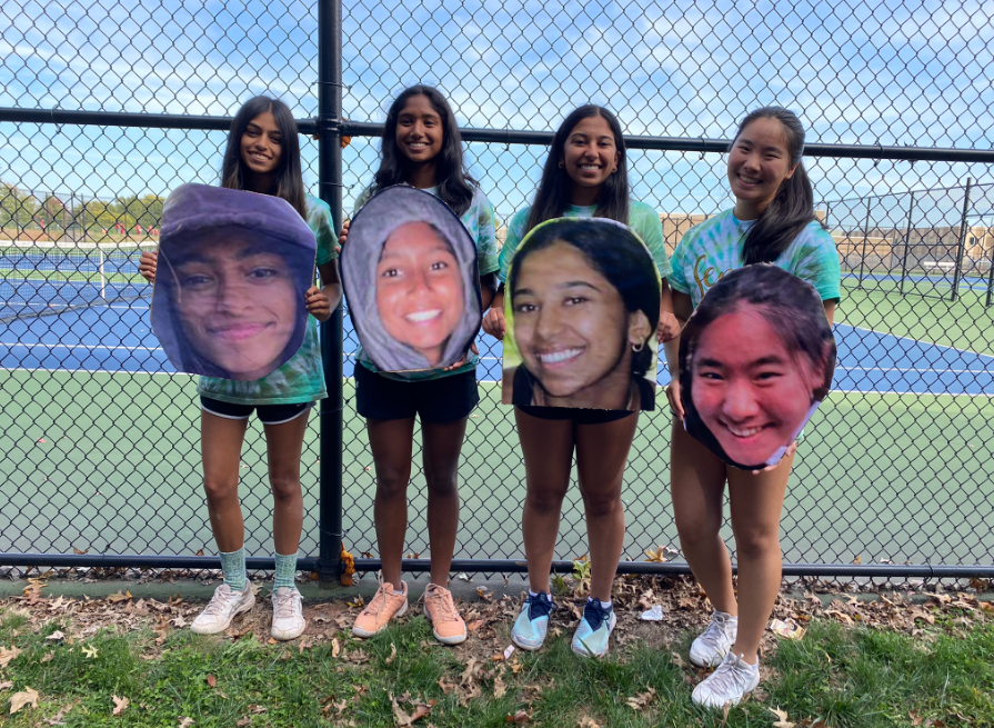 Members of the girls tennis team hold senior mementos.