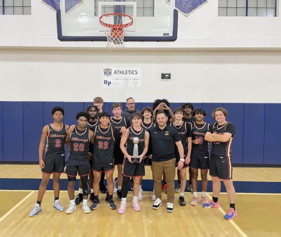 Boys Basketball poses with their trophy after a successful win in the Prep Holiday Tournament. 