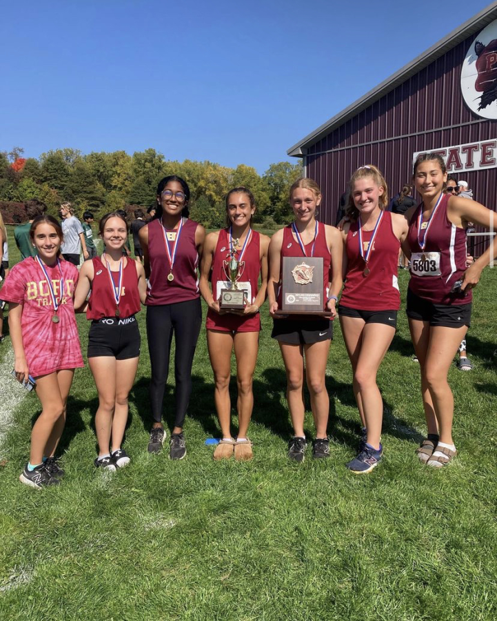 Runners Liana Dudajek, Emily Miller, Nivedha Sundarrajan, Sabrina Sardar, Lauren Barker, Anna King, and Adrianna Fetaya pose with their hardware at the Skyland Conference Championship.
