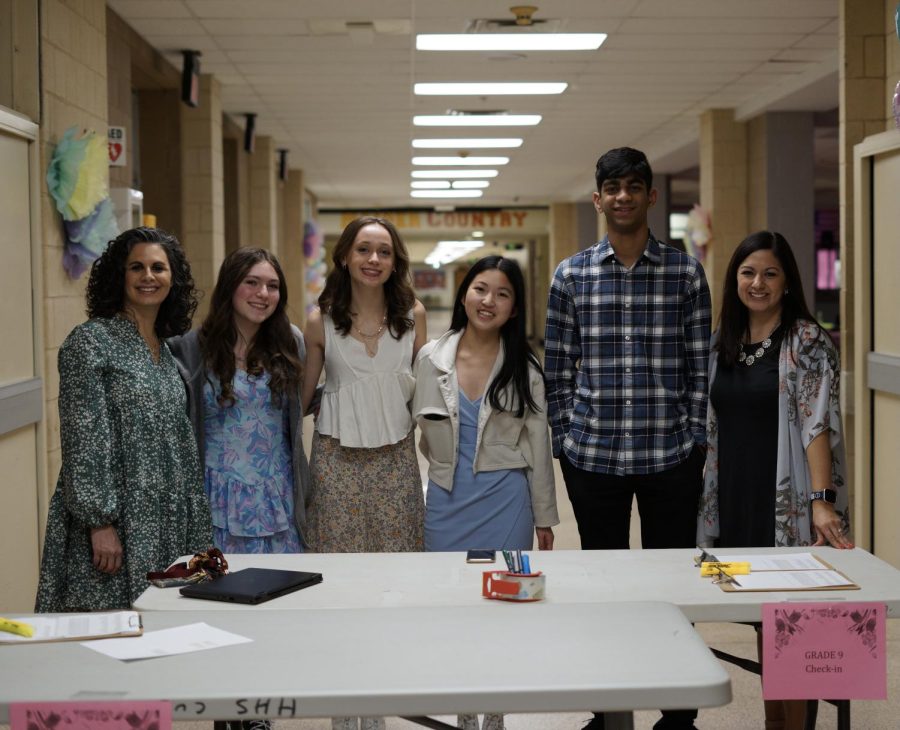 The Sophomore Class Cabinet stands ready to welcome in students to the dance.