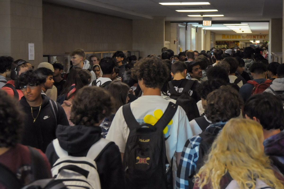 Pressed together, Hillsborough students attempt to navigate the crowded hallways during passing time.