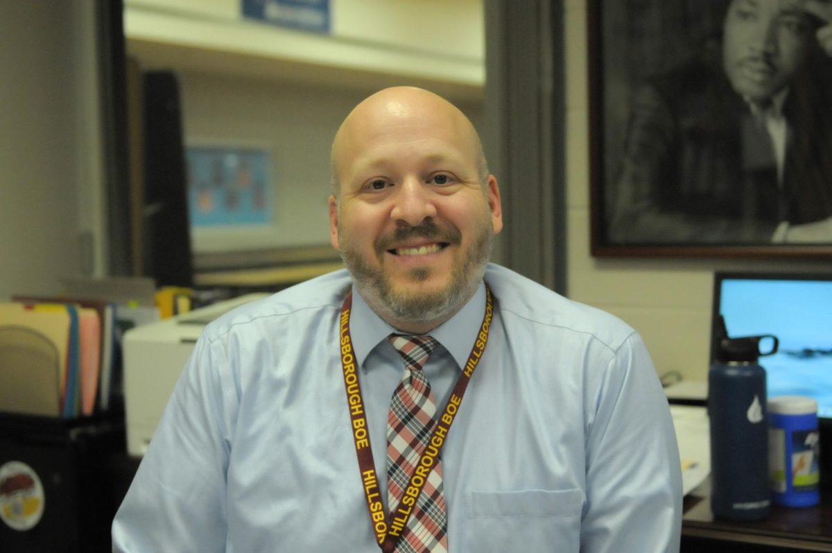 Principal DiLollo sits at his desk