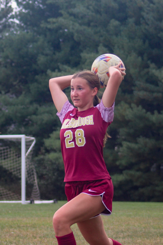 Sophomore Emery Pierson brings the ball over her head to throw into her teammate during the JV girls soccer match against Bridgewater.