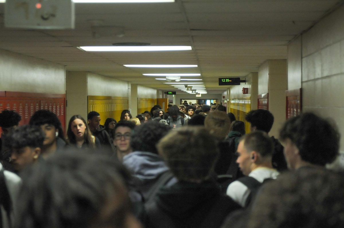 Students in the 100s hallway attempt to reach class at the end of Period 8