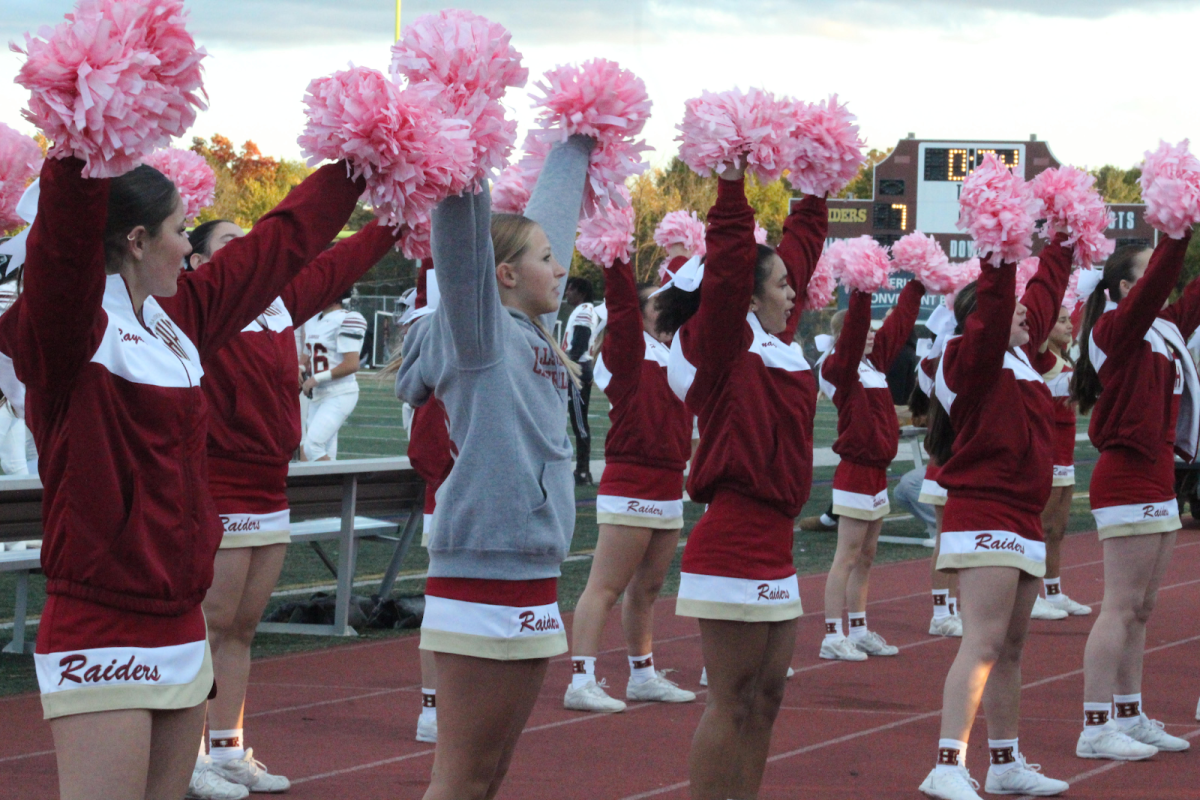 JV Cheerleaders hype up the student section during a football game