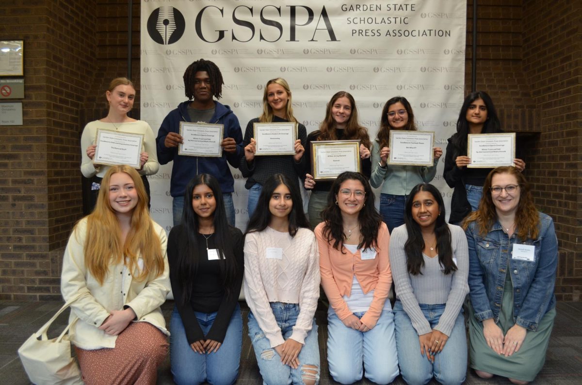 Members of the yearbook staff are pictured with awards that they received. 