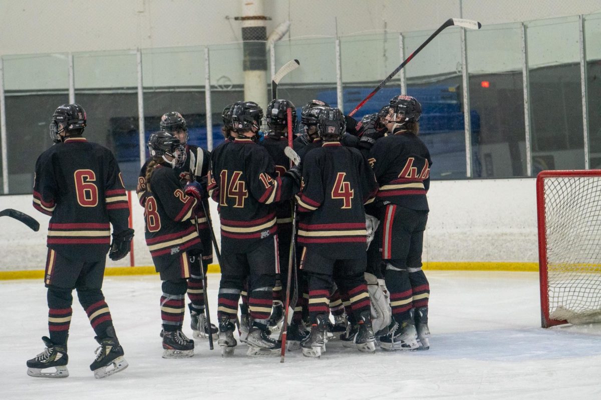 The boro ice hockey team huddles up during the 6-0 shutout against Watchung Hills, during the annual teddy bear toss game.