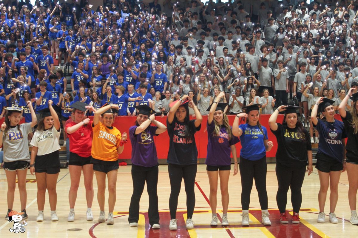  Seniors Rayna Vos, Olivia Kowal, Linnea Csernica, Lindsey Buisson, Demiana Moleski, Amanda Smith, Lauren Loniewski, Marissa Panchery, Eva Castano and Jessica Graham move the tassel of their graduation caps from right to left during the senior class dance.