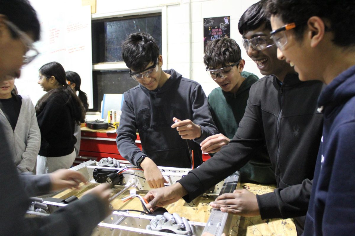 Members of Team 428 work on their robot.