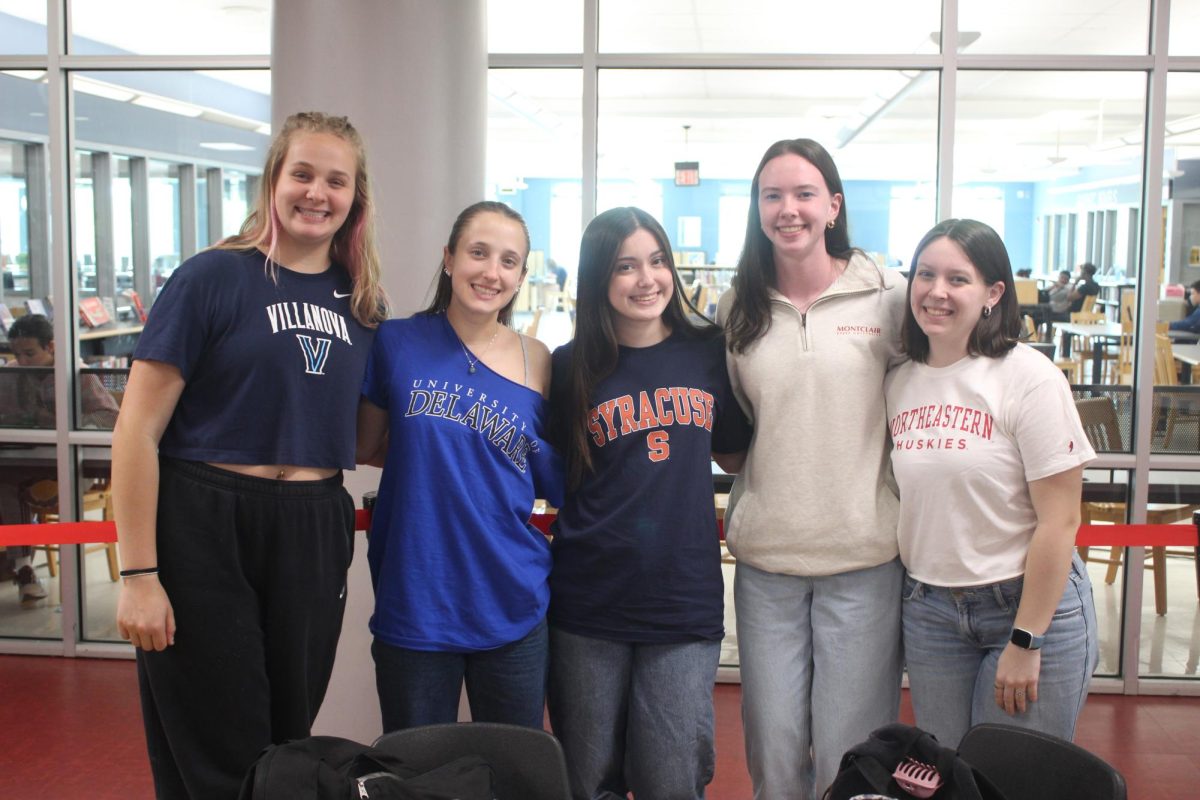 Seniors (left to right: Karolina Matejczyk, Emily Enna, Lily
Campbell, Mara McHugh, Addison Harkin) show off their
college gear. 