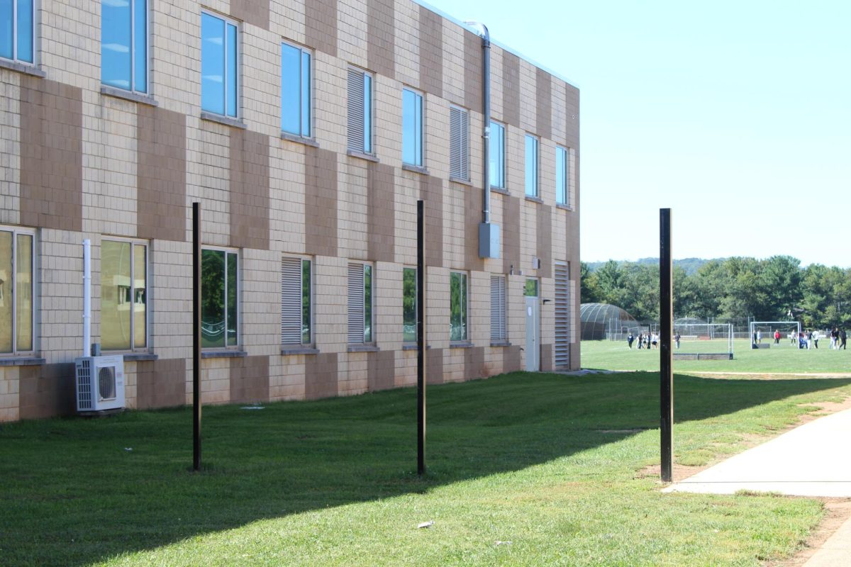 Stakes mark the perimeter of a fence in early October. The fence is one of the security upgrades planned for the Senior Courtyard.
