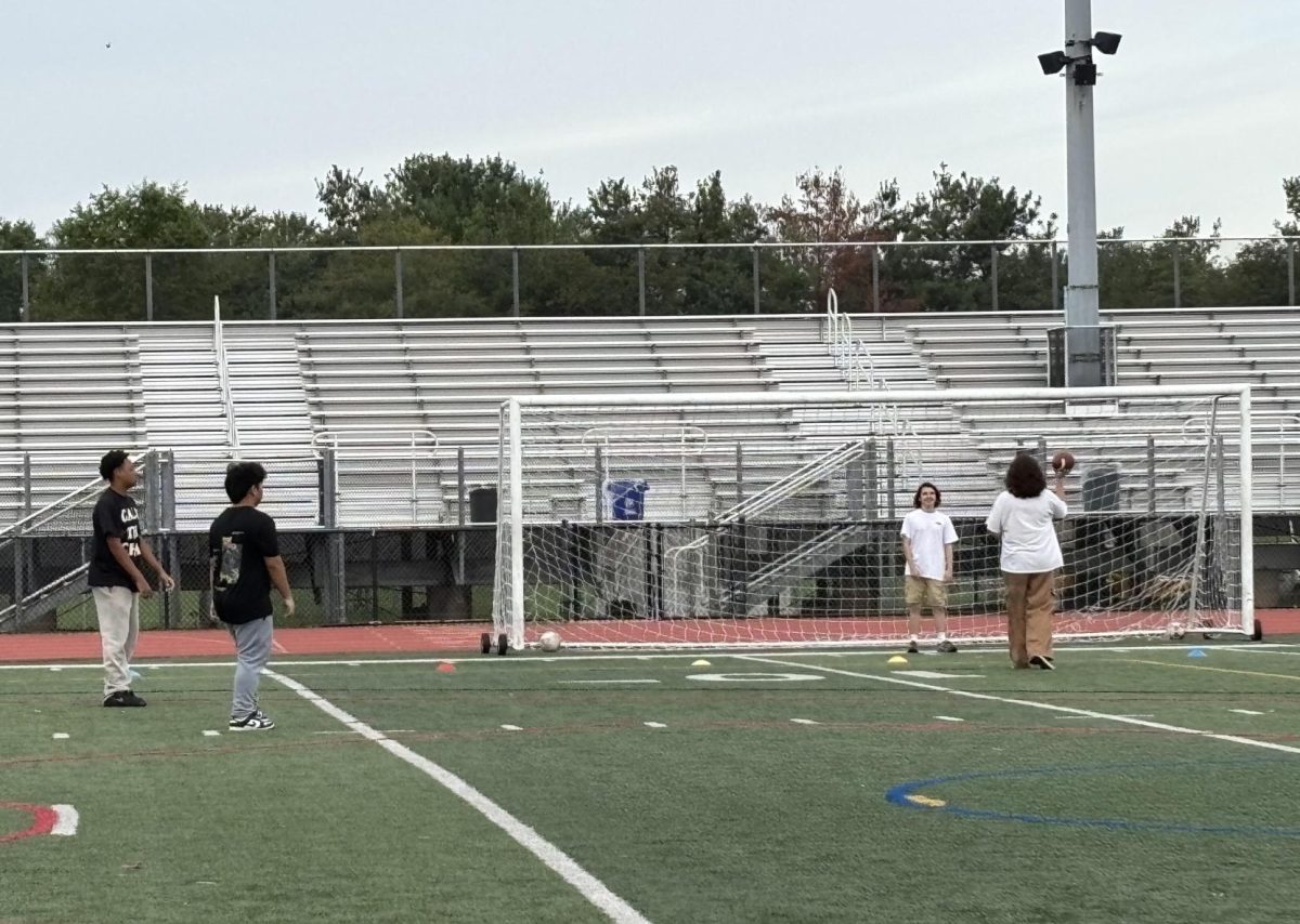 Juniors Chase Sherrod, Marley Payumo, Gabriel Arndt and others play football during period 2 physical education class in September.