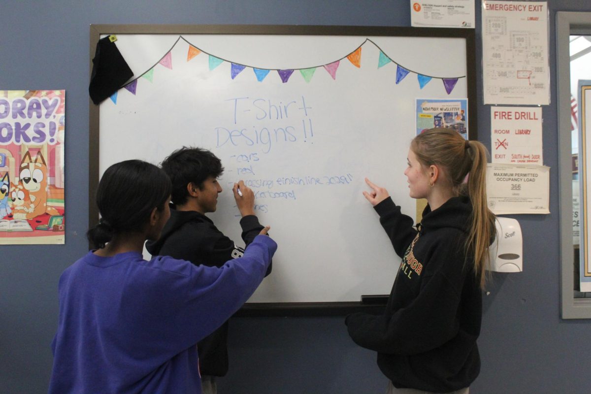 The Freshman Executive Board brainstorms t-shirt designs, pictured left to right: Ashley Michael, Advit Agarwal, Savannah Juzwa