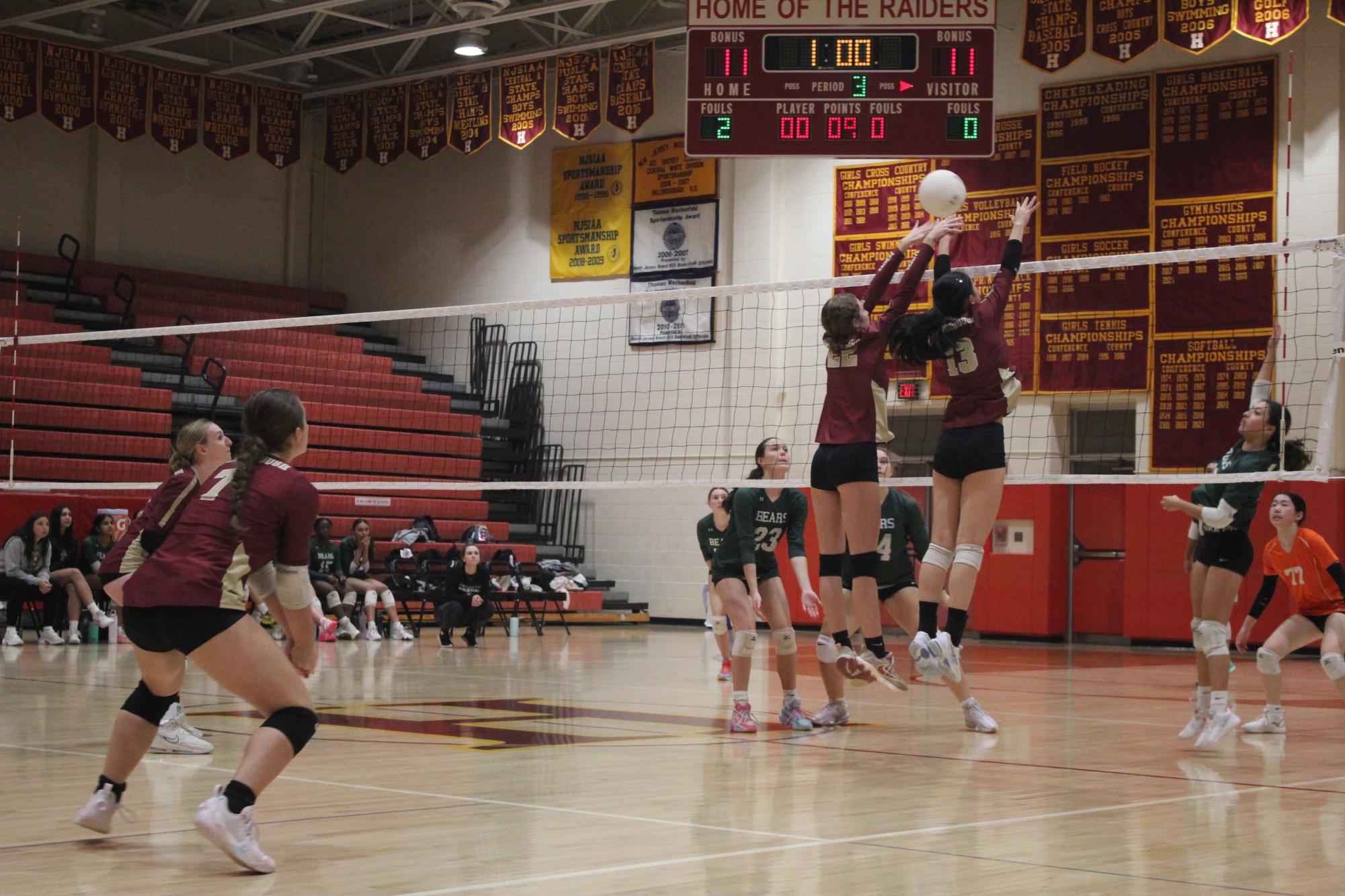 A bold double block by junior Alexa Gaspar and senior Cynthia Lei in the third as they reach above the net for a leading point.