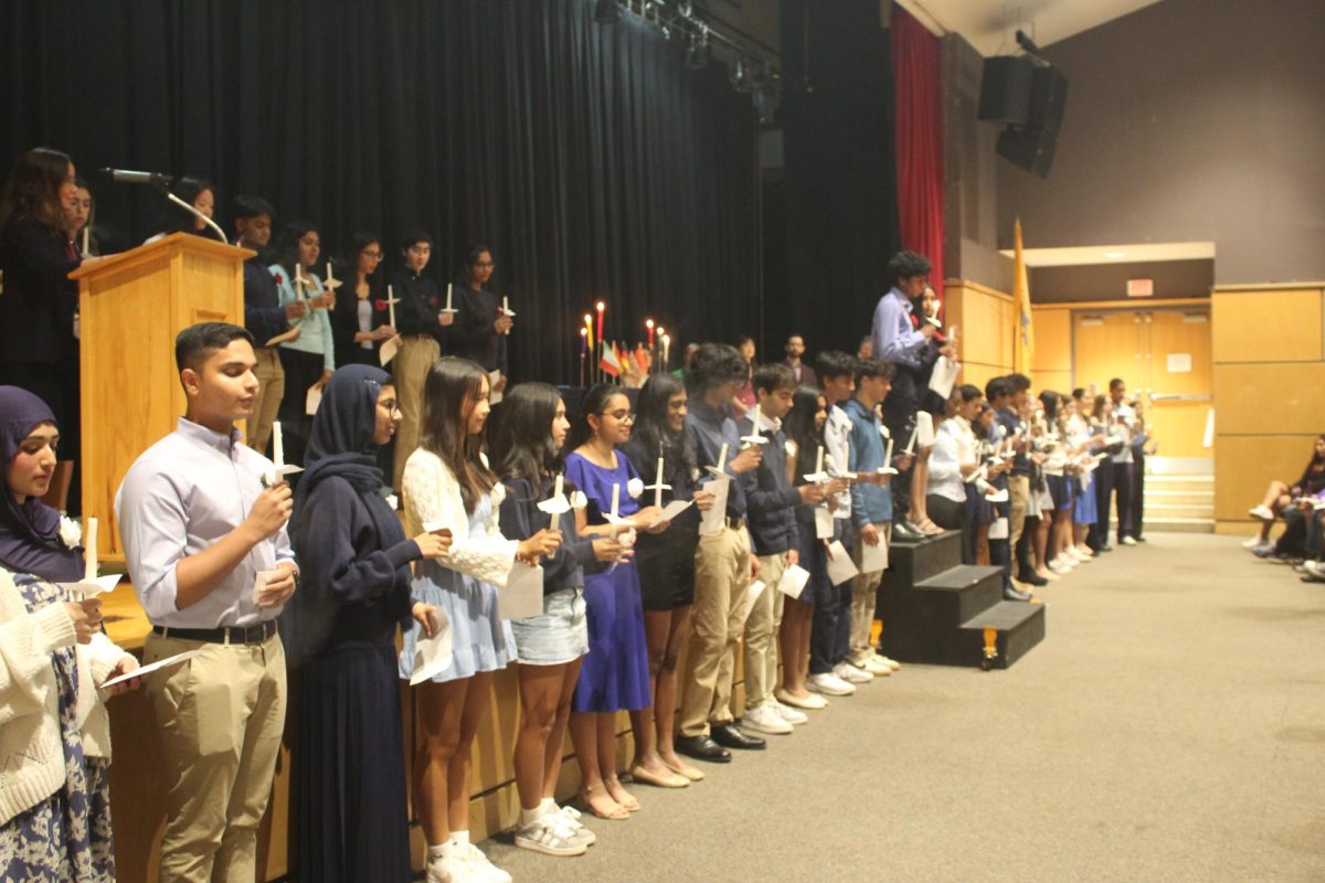 Members of the French Honor Society blow out their candles during the Induction ceremony.