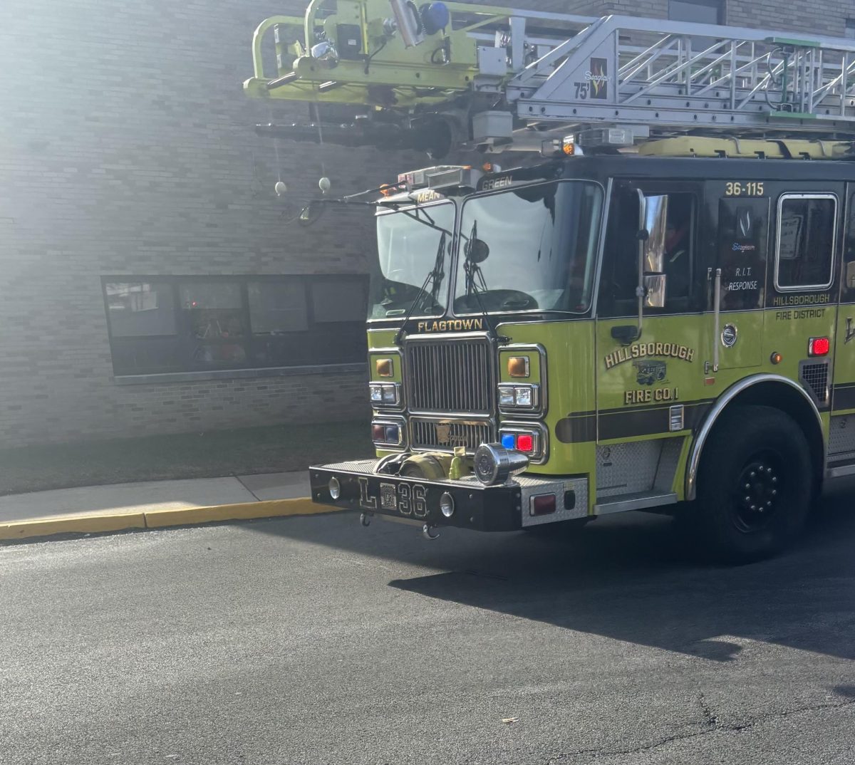 A firetruck arrives on the school campus.