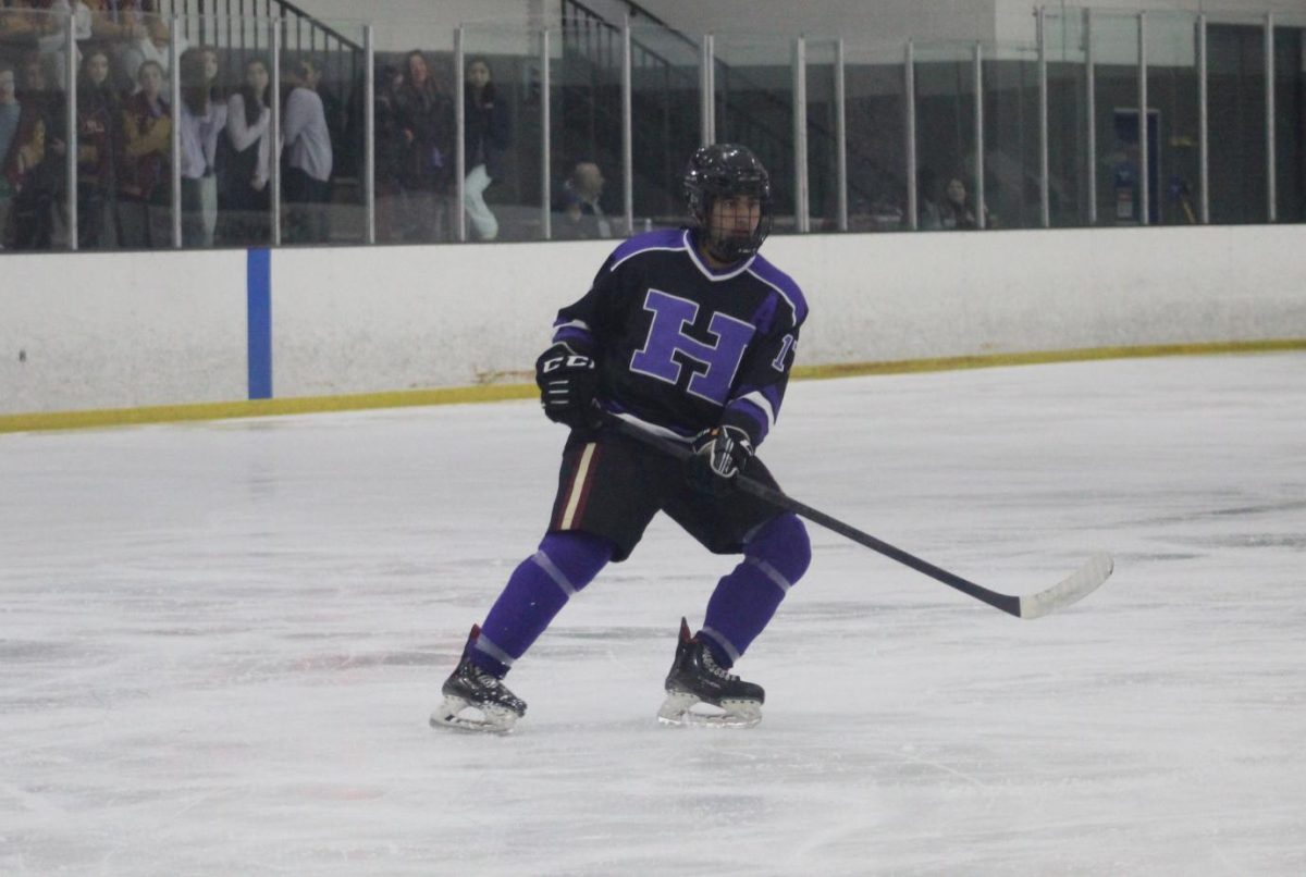 Senior Ansh Agarwal on the ice staying open for a teammate to pass the puck.