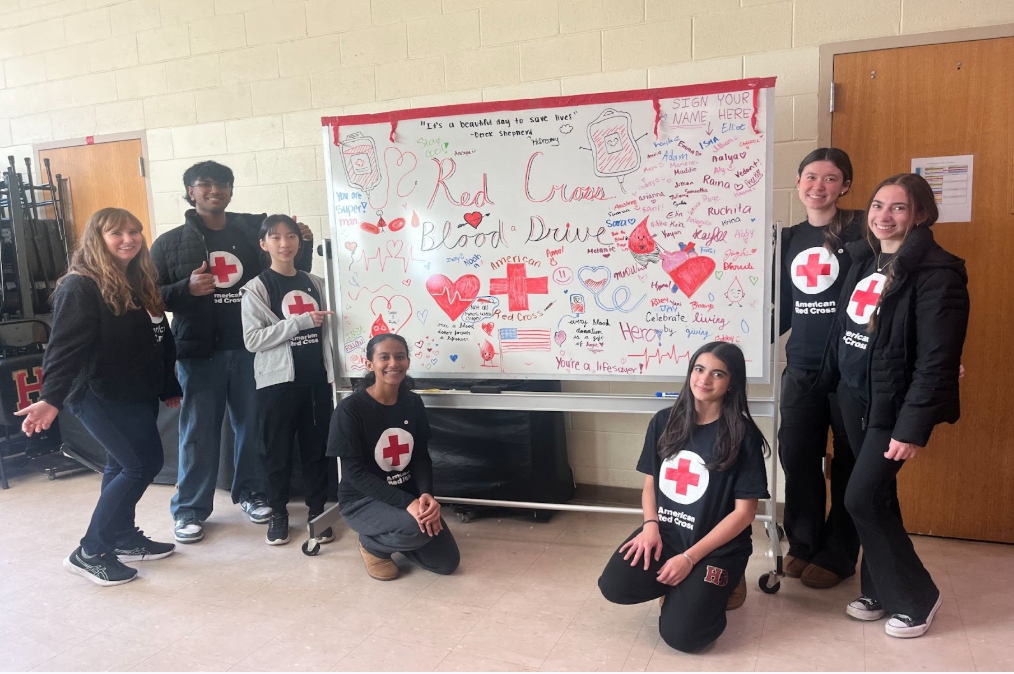 Red Cross Club members pose outside the Wrestling room.
