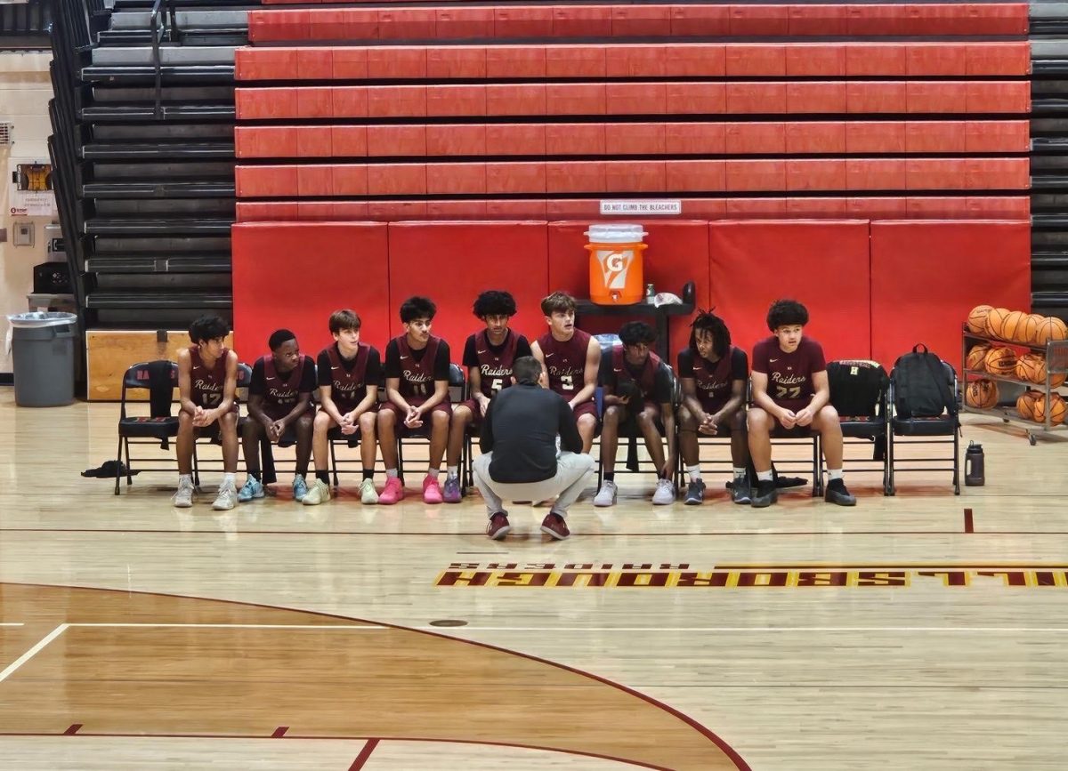The team sat together as the coach discussed the game plan going into the third quarter, making sure they held onto the lead.