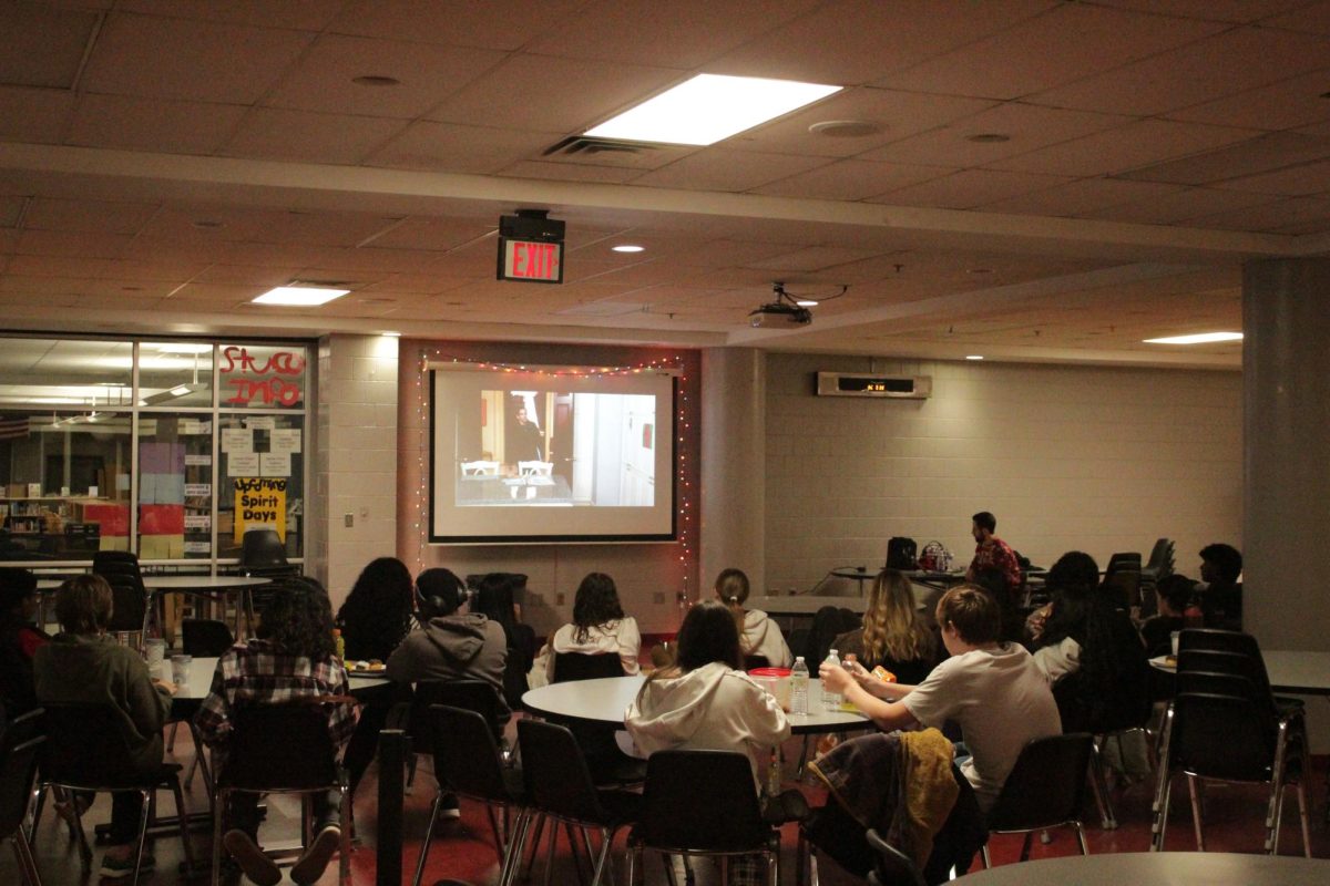 Attendees view the film “Night at the Museum” in the HHS commons.