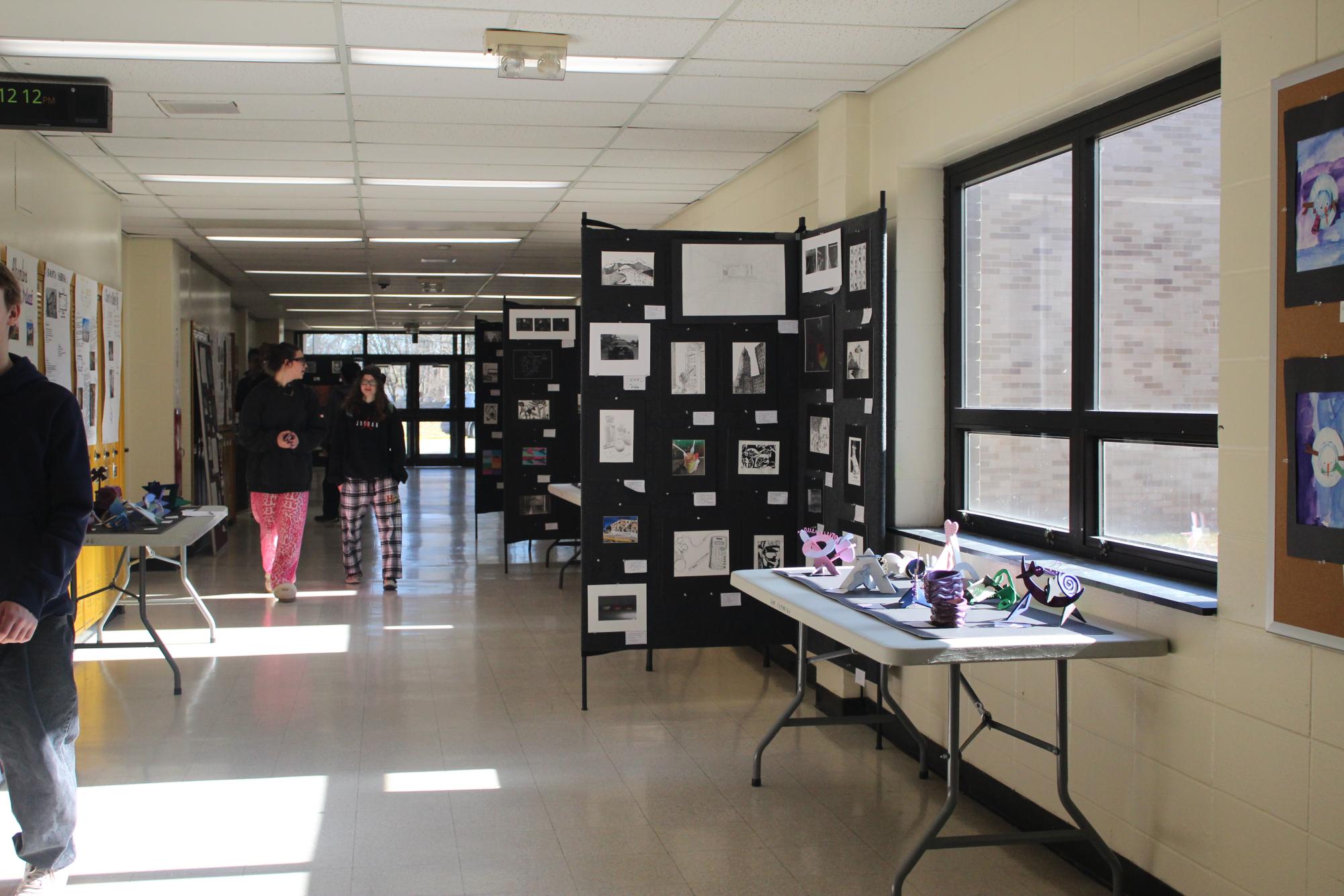 Student’s art work is displayed in the HHS art exhibit, showcasing a variety of different mediums all in one hallway.