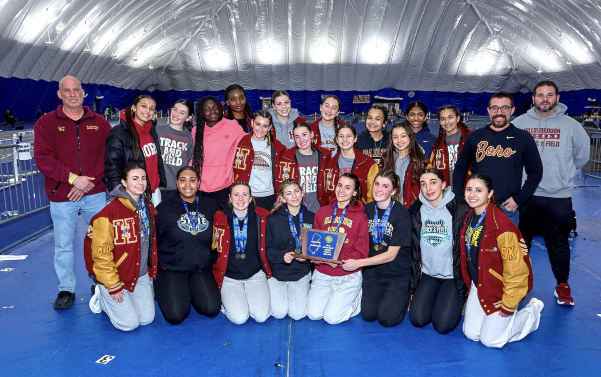 The girls indoor track team celebrate their state championship title earned after winning gold in the 4x400-meter relay.