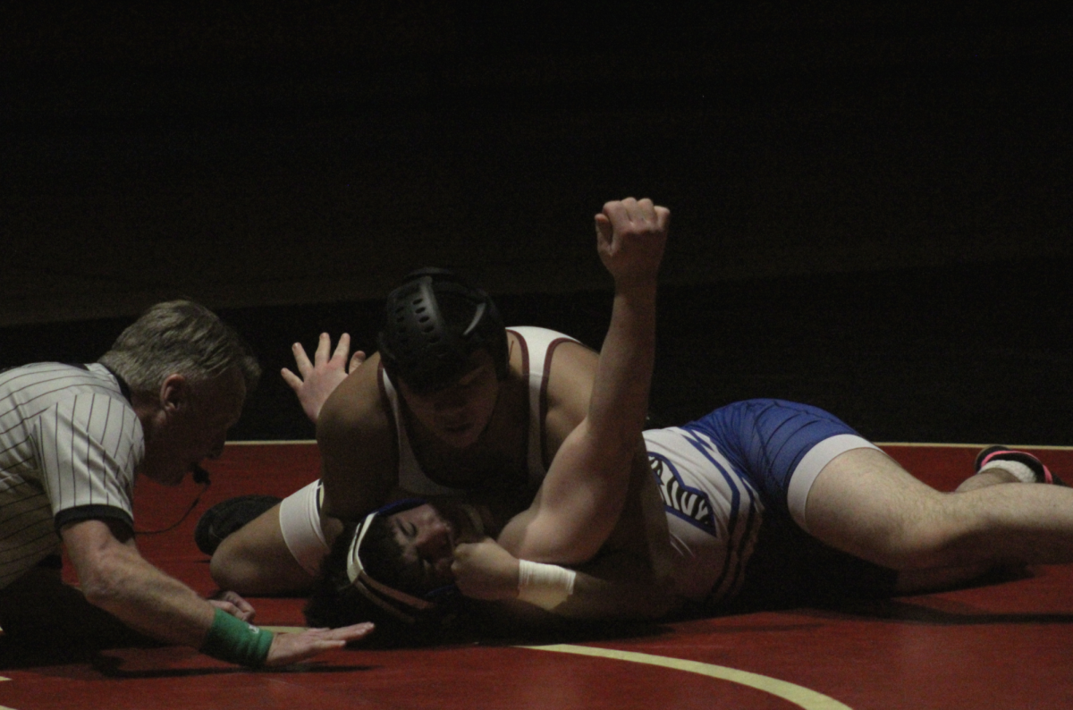 Senior Aren Hidalgo finalizes the night off with a crushing pin over Princeton athlete.