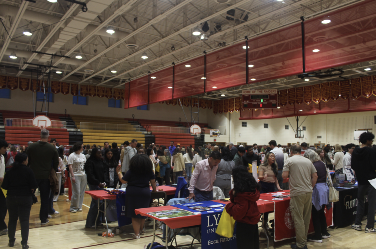 A wide view of the Hillsborough High School gym as hundreds of students and parents gather to meet with representatives from dozens of universities on Monday, March 16, 2026.